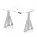 The photograph shows a sleek white desk with silver legs and a spacious 1200 x 800mm top. The desk is equipped with cable ports for easy organization and a piste foot for adjustable height. It can be used as a sit-stand desk for a dynamic work environment.