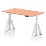 The picture shows a spacious 1400 x 800mm beech top desk, with white adjustable legs and a Piste foot for stability. Cable ports are present for a clean and organized workspace. The desk is height adjustable for sitting or standing, promoting a dynamic and comfortable work environment.
