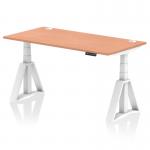 The image shows a dynamic sit stand desk with a height adjustable feature. It is 1600 x 800mm in size with a beech top and white legs. The desk also has built-in cable ports for organization. The unique piste foot adds stability and style to the desk.