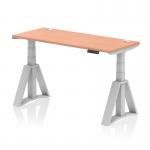 The picture shows a modern office desk with a sleek beech top, silver legs, and cable ports. It is 1400 x 600mm in size and has a dynamic sit-stand feature, allowing for easy adjustment of height. The desk also has a piste foot for added support and stability.