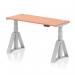 The picture shows a modern office desk with a sleek beech top, silver legs, and cable ports. It is 1400 x 600mm in size and has a dynamic sit-stand feature, allowing for easy adjustment of height. The desk also has a piste foot for added support and stability.