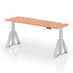 This photo features a dynamic sit-stand and height adjustable desk, measuring 1800 x 600mm. It has a beech top and silver legs with cable ports, and is also equipped with a piste foot for stability. The desk is designed for use in a modern office setting.
