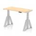 The photograph displays a sleek and modern office desk with dynamic sit-stand and height adjustable features. Its maple top and silver leg give a professional look, while the cable ports provide convenience. The Piste Foot adds stability to the piece.
