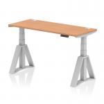 This picture features a sleek and modern office desk with a height adjustable feature. The desk has a stylish oak top and silver legs, with cable ports and a piste foot for added functionality. Its dimensions are 1400mm x 600mm, making it a perfect fit for any workspace.