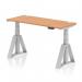 This picture features a sleek and modern office desk with a height adjustable feature. The desk has a stylish oak top and silver legs, with cable ports and a piste foot for added functionality. Its dimensions are 1400mm x 600mm, making it a perfect fit for any workspace.