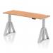 This image showcases a modern, sleek office desk that is both dynamic and versatile. The desk features a 1600 x 600mm oak top, with height adjustability, cable ports, and a silver leg with a piste foot for added stability. Perfect for any ergonomic workspace.