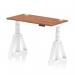 This photograph features a sleek, modern office desk in walnut with a white adjustable leg and cable ports. The desk is 1200 x 600mm and has a dynamic sit-stand feature, as well as a piste foot for added stability. It is perfect for creating a versatile and organized workspace.