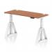 This picture shows a modern Dynamic Sit Stand and Height Adjustable Desk with a 1400 x 600mm walnut top. The desk has cable ports for a clean workspace and a sleek white leg with a piste foot. Perfect for a versatile and ergonomic office setup.