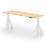 The photo shows a sleek, modern office desk with a maple top and white adjustable legs. Cable ports and a Piste Foot allow for easy organization and customizable height options. The dynamic design of this 1800 x 600mm desk is perfect for any active workspace.