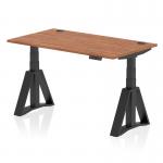 This picture shows a dynamic sit stand and height adjustable desk with a sleek walnut top and modern black legs. The desk measures at 1400 x 800mm and features cable ports for easy organization. The innovative piste foot provides stability while in standing position.