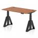 This picture shows a dynamic sit stand and height adjustable desk with a sleek walnut top and modern black legs. The desk measures at 1400 x 800mm and features cable ports for easy organization. The innovative piste foot provides stability while in standing position.