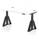 The image shows a sleek and modern office desk with a white top and black legs. It is equipped with cable ports and a Piste Foot for added stability. The desk is able to adjust in height, allowing for both sitting and standing positions. Its dimensions are 1600 x 800mm.