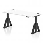 This photo features a sleek 1800 x 800mm white top desk with black legs and a Piste Foot, designed for height adjustability and improved ergonomics in the office. Cable ports can be seen on the surface for easy organization.