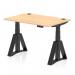 In the photograph, we see a sleek and modern desk with a maple top and black legs. It has a dynamic sit-stand feature and measures 1200 x 800mm. The desk also has cable ports for easy organization and a piste foot for stability. It would be a great addition to any office space.