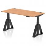 The image shows a sleek and modern office desk with an oak top and black legs. The desk is 1600 x 800mm and features height adjustability, with visible cable ports for organization. The unique piste foot adds a touch of style and functionality.