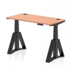 This photograph features a sleek and modern Dynamic Sit Stand and Height Adjustable Desk in the dimensions of 1200 x 600mm. The desk has a beech top and black legs with a Piste Foot design, and also includes cable ports for convenient organization. The height of the desk is adjustable, making it perfect for any office setting.