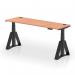 This photo shows a dynamic sit stand and height adjustable desk, measuring 1800 x 600mm, with a beech top and black legs. The desk features cable ports and a piste foot for added comfort and versatility.