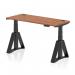 The picture shows a sleek black desk with a walnut top. It has a dynamic sit-stand feature and is height adjustable up to 1400 x 600mm. The desk also has cable ports and a stylish piste foot on the black legs.