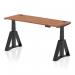This image features a sleek and modern 1600 x 600mm walnut top office desk with black legs and a piste foot. The desk is height adjustable, perfect for those who prefer the option of sitting or standing while working. It also includes cable ports for easy organization and a dynamic sit stand feature.