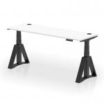 This photo shows a sleek and modern dynamic sit stand and height adjustable desk. It features a white tabletop with cable ports, paired with a black leg and piste foot for stability. The desk measures 1800 x 600mm and is perfect for any office setting.