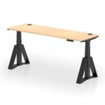 The photo shows a modern workspace with a sleek, 1800 x 600mm maple top desk. The black legs have a piste foot for stability and there are convenient cable ports for organization. The desk is height adjustable and can easily convert from sitting to standing for a dynamic work experience.