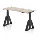 This picture features a sleek and modern office desk, measuring 1400 x 600mm, with a grey oak top and black legs. The desk is fully height adjustable and comes with cable ports and a piste foot for added convenience. Ideal for creating a dynamic and ergonomic workspace.