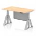 This picture shows a dynamic sit stand and height adjustable desk. The desk has a 1400 x 800mm maple top and silver legs, along with a silver steel modesty panel and piste foot. The desk can be easily adjusted to suit your preferences and promote a healthier work environment.