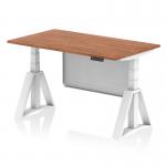 This picture shows a modern office desk with a walnut top and white steel legs. The desk is 1400 x 800mm and has a dynamic sit stand feature, allowing for easy height adjustment. It also includes a white steel modesty panel and piste foot for added support.