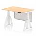The photo captures a sleek Dynamic Sit Stand desk with a 1200 x 800mm maple top, white steel legs, and a white steel modesty panel. The desk also features height adjustability and a piste foot for added support.
