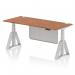 This photo features a sleek and modern office desk measuring 1800 x 800mm. The desk is height adjustable and boasts a walnut top with cable ports, silver legs, and a piste foot for added stability. The silver steel modesty panel adds a touch of style to this dynamic sit stand desk.