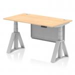 This picture depicts a sleek 1400 x 800mm height adjustable office desk with a maple top and silver leg. It also features a silver steel modesty panel, cable ports, and a piste foot for added stability. The desk is versatile, allowing you to switch between sitting and standing positions throughout the day.