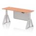 This image shows a modern office desk with a beech top and silver legs, featuring height and sit-stand adjustability. The desk also has cable ports for easy organization and a silver steel modesty panel for added privacy. The piste foot design gives it a sleek and dynamic look.