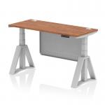 This picture features a dynamic sit stand and height adjustable desk, measuring 1400 x 600mm, with a walnut top and silver leg. It also includes cable ports and a silver steel modesty panel, along with a piste foot for added support.