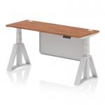 This adjustable desk features a sleek walnut top and modern silver legs with a matching steel privacy panel. It also includes cable ports for convenient organization and a piste foot for added stability. The desk measures 1600 x 600mm and is designed to be easily adjusted for sitting or standing.