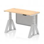 This photograph showcases a sleek and practical office space with a dynamic sit-stand desk. The 1200 x 600mm maple top is complemented by silver legs and a modesty panel, while a cable port and piste foot add functionality. The height adjustability allows for personalized comfort.