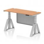 This picture features a sleek and modern height adjustable desk with an oak top and silver legs. The desk also has built-in cable ports and a modesty panel, with a piste foot for added stability. Perfect for creating a dynamic and ergonomic workspace.