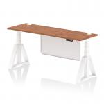 The photo shows a sleek and modern office desk with a walnut top and white steel legs. It is height adjustable and features cable ports and a white steel modesty panel. The air modesty desk is 1800 x 600mm and has a piste foot for added stability.