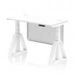 The photograph shows a sleek and modern height adjustable office desk, measuring 1200 x 600mm with a white top and steel modesty panel. The white legs are paired with a piste foot for added stability. Cable ports can be seen on the desk surface, providing convenience for managing wires. This desk offers the flexibility to switch between sitting and standing, promoting a healthier and more dynamic work environment.