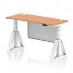 This picture features a sleek and modern desk with a oak top and white steel legs. The desk is 1400 x 600mm in size and has cable ports for easy organization. The desk is also height adjustable, with a dynamic sit stand feature for improved comfort. The white steel modesty panel adds a touch of elegance, and the piste foot adds stability.
