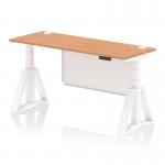 This image shows a 1600 x 600mm height adjustable office desk with an oak top and white steel legs. It features cable ports and a white steel modesty panel with a piste foot. The desk is designed for dynamic sit stand use and has a modern and functional appearance.