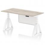 This picture showcases a dynamic sit stand and height adjustable desk with a grey oak top and white leg. It features a white steel modesty panel and piste foot. The desk measures 1600 x 800mm and is perfect for any office setting.