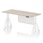 The photo features a versatile Dynamic Sit Stand and Height Adjustable Desk, measuring 1800 x 800mm. The desk boasts a stylish grey oak top and white leg, along with a white steel modesty panel and piste foot for added stability. The height adjustability allows for customized comfort while working.