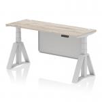 This image features a sleek grey oak top on a 1600 x 600mm height adjustable office desk, with a silver leg and modesty panel. The desk also includes cable ports for organization and a piste foot for added stability.