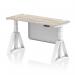 This picture features a sleek grey oak top on a white adjustable desk with cable ports and a steel modesty panel. The white legs and piste foot give it a modern and professional look.