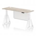 The image shows a sleek and modern office desk with a grey oak top and white leg. It is height adjustable and has cable ports for easy organization. The white steel modesty panel adds a clean and professional touch, while the built-in piste foot provides stability. This desk is perfect for any dynamic and productive work environment.