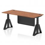 This photo shows a sleek and modern dynamic sit stand and height adjustable desk. It features a walnut top with cable ports and a black steel modesty panel. The desk is 1800 x 800mm and has adjustable legs with a black piste foot.
