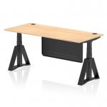 The photo shows a dynamic sit stand and height adjustable desk with a 1800 x 800mm maple top and black steel modesty panel. It has cable ports and a piste foot for support. The desk is set to a standing height and has a modern, sleek design.