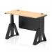 This photograph features a dynamic sit-stand desk, with a 1200x600mm maple top and black steel modesty panel. The desk is height adjustable and includes cable ports, along with black legs and a piste foot.