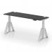The image features a sleek office desk with a black top and silver legs, measuring 1800 x 600mm. It is height adjustable and equipped with cable ports for a clutter-free workspace. The desk also comes with a piste foot for added stability and support.