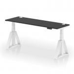 This photo displays a dynamic sit-stand and height adjustable desk measuring 1800 x 600mm. It features a sleek black top with cable ports, supported by white legs and a piste foot for added stability. A practical addition to any office space.
